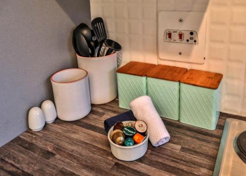 a kitchen counter with two containers of utensils and a counter top with at 207 La Ballito-Luxury Family apartment in Ballito