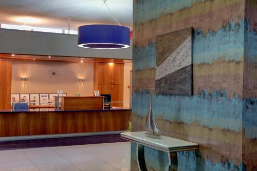 a lobby of a hospital with a vase on a table at Best Western Aberavon Beach Hotel in Port Talbot
