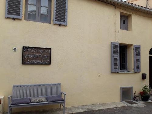 a bench in front of a building with a sign at Casa Franceschi in Pioggiola