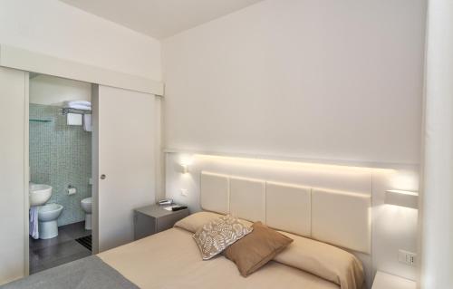 a bedroom with a bed with a light above it at Hotel Hermitage in Marina di Massa