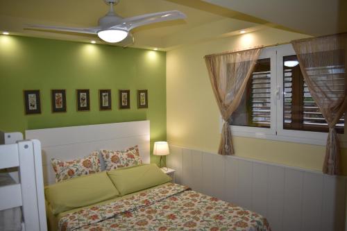 a bedroom with a bed and a ceiling fan at VILLA GARDEN in Tarragona