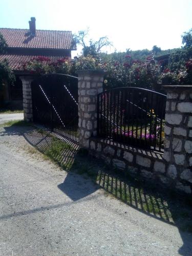 a wrought iron fence with a stone wall at Sobe Seka in Golubac