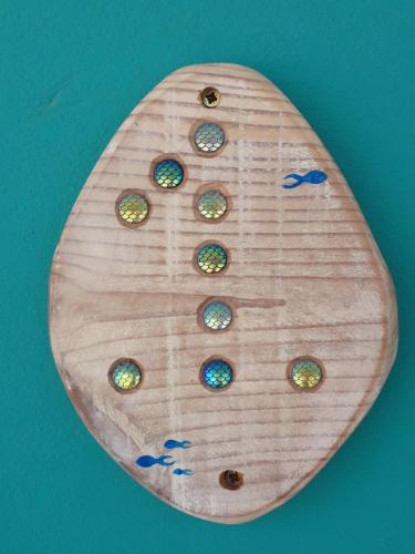 a wooden surfboard with buttons on a blue background at B&B Sereia Azul Boa Vista in Sal Rei