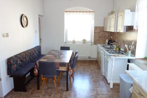 a kitchen with a table and a dining room at chalupa in Hora Svatého Šebestiána