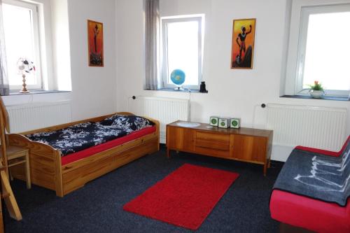 a bedroom with two beds and a table and windows at chalupa in Hora Svatého Šebestiána