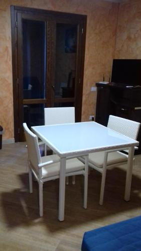 a white table with white chairs and a piano at Tenuta del Bifan in Policastro Bussentino