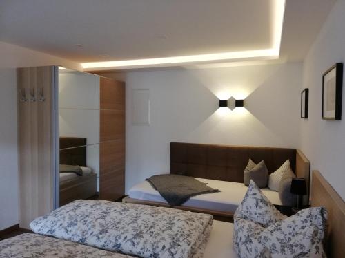 a small bedroom with a bed and a mirror at APART BRADL in Hippach