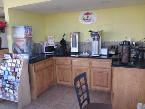 a kitchen with a counter with a coffee shop at Super 8 by Wyndham Lubbock Civic Center North in Lubbock