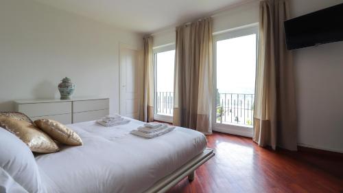 a bedroom with a bed and a large window at Italianway - San Bartolomeo 7 in Rapallo