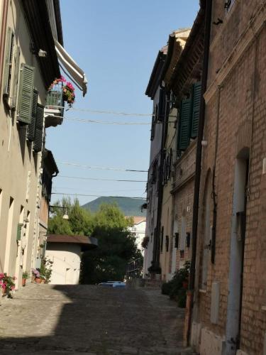 an alley in a town with buildings with green shutters at Relais B in Ancona