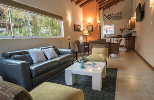 a living room with a couch and a table at Costa Esmeralda Village in Palm-Eagle Beach