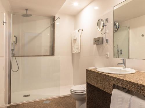 a bathroom with a shower and a toilet and a sink at Hotel Boa - Vista in Porto