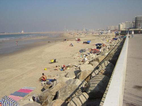 a group of people laying on the beach at Hotel Boa - Vista in Porto