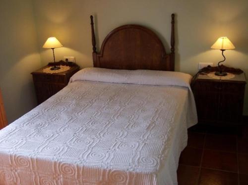 a bedroom with a large bed with two night stands at Tossal del Maig in Barbará