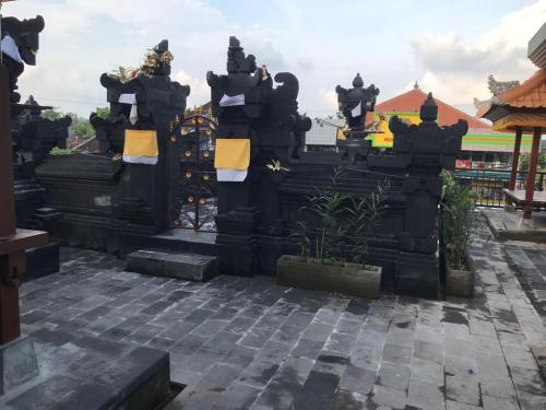 a gate at a temple in a city at Grey House Monkey Forest in Ubud