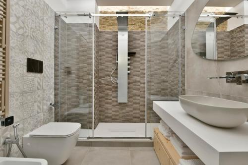 a bathroom with a toilet and a sink and a shower at Amnis suites in Santa Maria di Castellabate