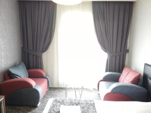 a living room with two chairs and a table at Blue Vip House in Beylikduzu