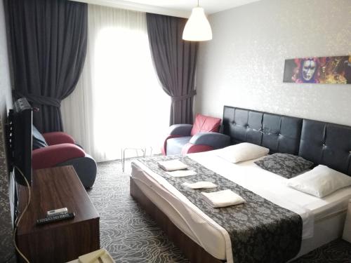 a hotel room with a bed and a couch at Blue Vip House in Beylikduzu