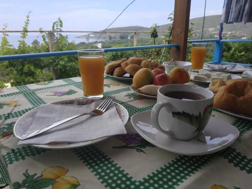a table with a plate of food and a cup of coffee at Casa Qeparo in Qeparo