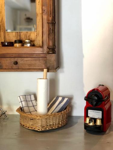 a counter with a basket and a toaster and a mirror at Nefeli in Livadion