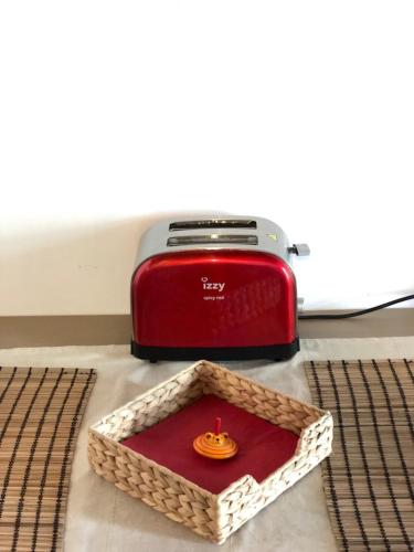 a red toaster sitting on top of a table at Nefeli in Livadion
