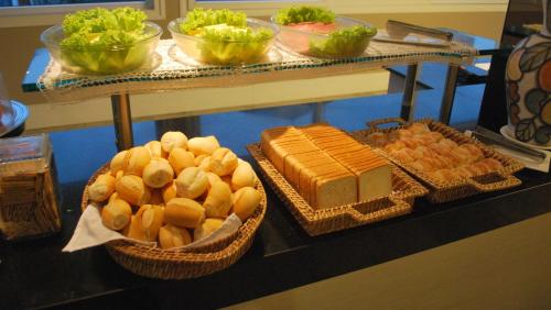 a buffet with bread and other foods on a table at Hotel Barramares in Recife