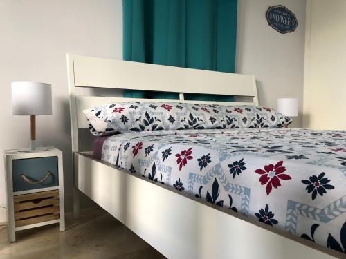a bedroom with a bed with a floral bedspread at CriteriaHome! nice&easy in Madrid