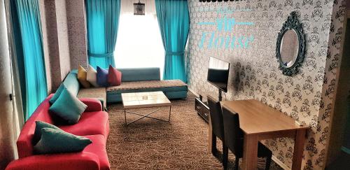 a living room with a red couch and a mirror at Blue Vip House in Beylikduzu