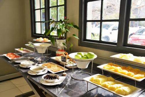 a buffet with many different types of pastries on a table at The Capetonian - Halal in Cape Town