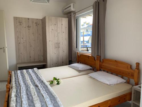 a small bedroom with a bed and a window at helios apartmenthouse in Olympic Beach