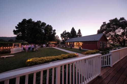 a backyard with a white fence and a building at The Setting Inn Napa Valley in Napa