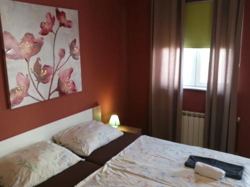 a bedroom with a bed and a painting on the wall at City Break Rooms Zagreb in Zagreb