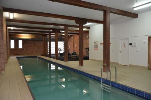 a swimming pool with blue water in a building at Frisco Apartments in Brisbane