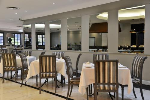 a restaurant with tables and chairs and a counter at The Capetonian - Halal in Cape Town
