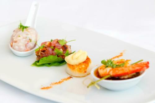 a plate of food with vegetables and a salad at Sofitel Noosa Pacific Resort in Noosa Heads