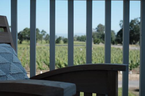 a person sitting on a bench looking out at a field at The Setting Inn Napa Valley in Napa