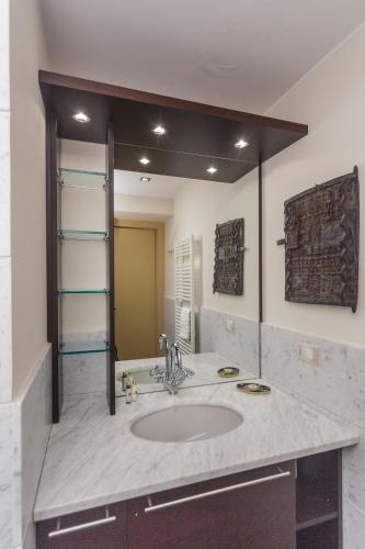 a bathroom with a sink and a large mirror at VILLA AURORA Relax con Vista Mare e Piscina in Camogli