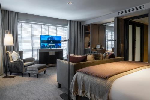 a hotel room with a bed and a television at Dakota Manchester in Manchester