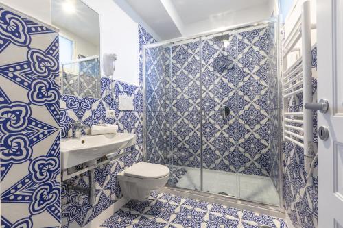 a blue and white bathroom with a toilet and a shower at Blue View Capri Apartment in Capri