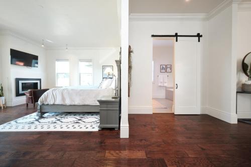 a bedroom with a bed and a living room with white walls at The Setting Inn Napa Valley in Napa