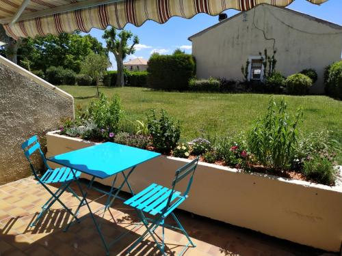 two chairs and a table on a patio at L'instant Canal in Capestang