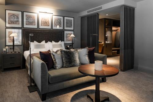 a bedroom with a bed and a couch and a table at Dakota Manchester in Manchester