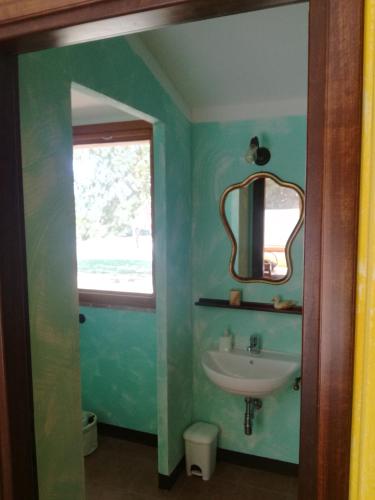 a bathroom with a sink and a mirror at Casetta Francini in Civitella Marittima