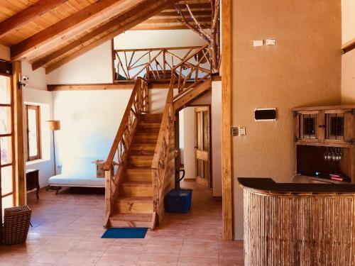 a living room with a staircase in a house at Casa Alma del Elqui Paihuano in Paihuano