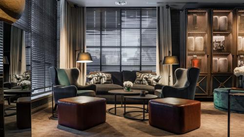 a living room filled with furniture and a large window at Dakota Manchester in Manchester