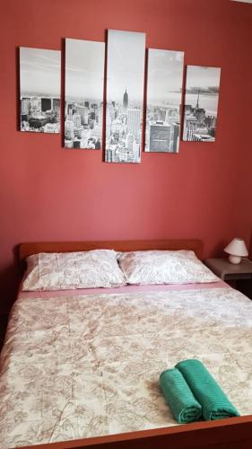 a bedroom with a bed with four pictures on the wall at City Break Rooms Zagreb in Zagreb