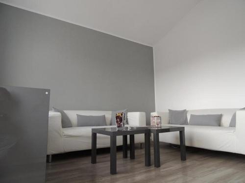 a living room with a white couch and a table at Pensiunea Sada in Cluj-Napoca