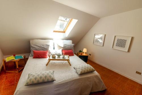 a bedroom with a bed with a table on it at LA MANSARDINA VINTAGE in San Benedetto del Tronto