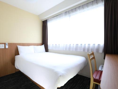 Кровать или кровати в номере Hotel Wing International Korakuen