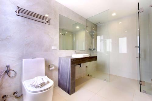 a bathroom with a toilet and a sink and a shower at Phoenix Hotel Karon Beach in Karon Beach